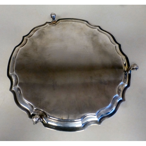 2 - A silver salver with a piecrust border, raised on scrolled feet&nbsp; Sheffield 1990&nbsp; 10