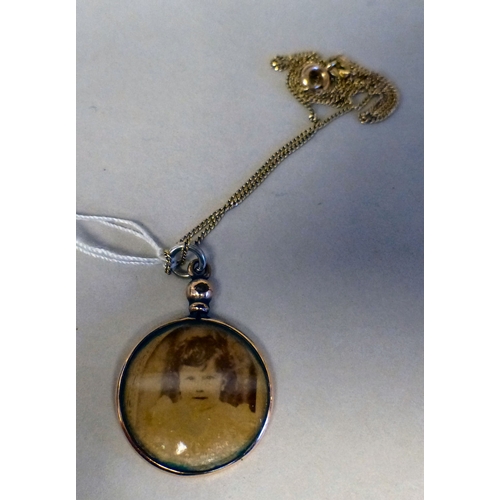25 - A yellow metal framed double sided pendant locket, on a 14ct gold chain&nbsp; (the chain approx. 1.3... 