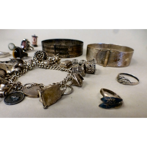 26 - Silver and white metal items of personal ornament: to include a charm bracelet; and two bangles