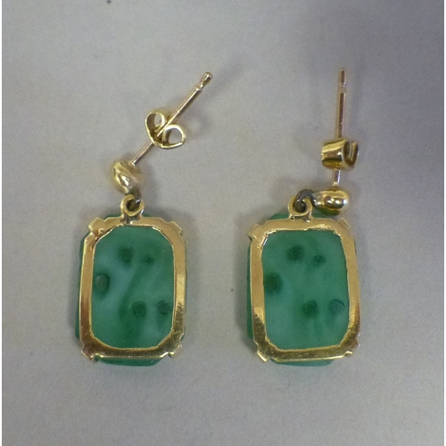 39 - A pair of Chinese yellow metal jade set earrings