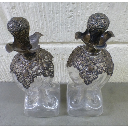 52 - A pair of late Victorian silver capped and collared, clear glass 'cluck-cluck' decanters  Birmingham... 