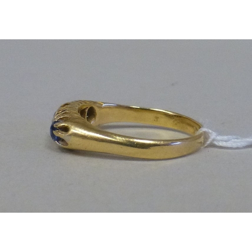 57 - An 18ct gold ring, set with blue stones and alternating diamonds&nbsp; (approx. 4grms)