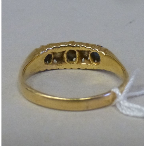 57 - An 18ct gold ring, set with blue stones and alternating diamonds&nbsp; (approx. 4grms)