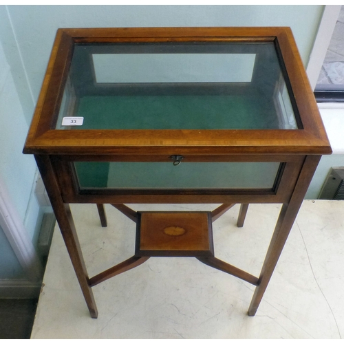 An early/mid 20thC stained beech framed, partially glazed display table ...