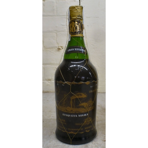 15 - A bottle of Baron de Sigognac Armagnac, in a wooden box; and a bottle of Etiqueta Negra Gran Reserva... 