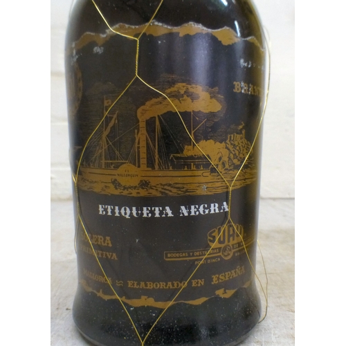 15 - A bottle of Baron de Sigognac Armagnac, in a wooden box; and a bottle of Etiqueta Negra Gran Reserva... 