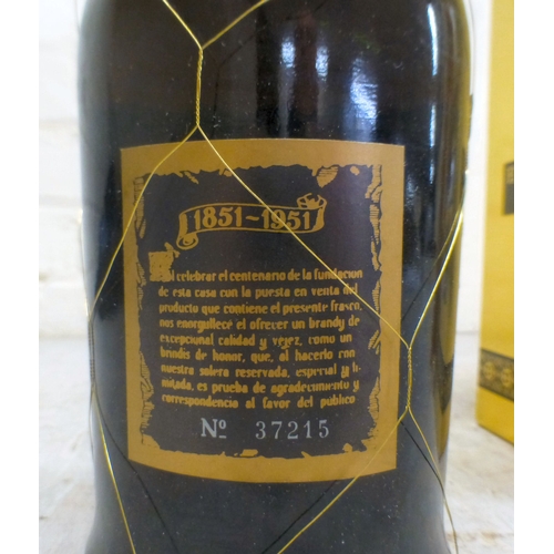 15 - A bottle of Baron de Sigognac Armagnac, in a wooden box; and a bottle of Etiqueta Negra Gran Reserva... 