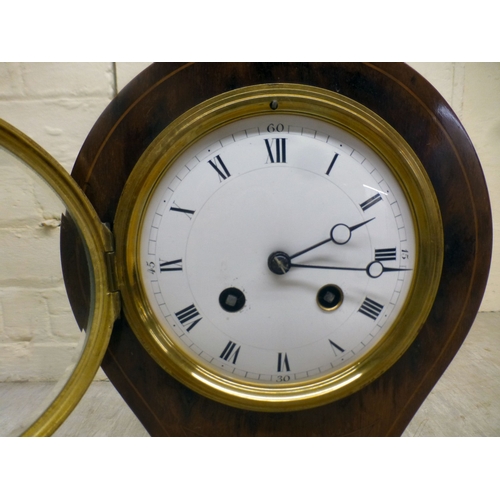 22 - An Edwardian string inlaid mahogany, balloon design mantel clock; the movement faced by a Roman dial... 
