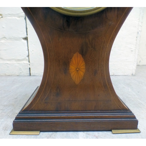 22 - An Edwardian string inlaid mahogany, balloon design mantel clock; the movement faced by a Roman dial... 