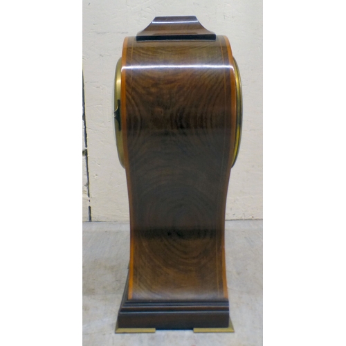 22 - An Edwardian string inlaid mahogany, balloon design mantel clock; the movement faced by a Roman dial... 
