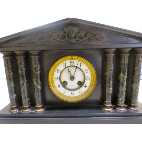 26 - An early 20thC black slate and marble mantel clock of architectural form, on a plinth; the movement ... 