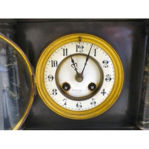 26 - An early 20thC black slate and marble mantel clock of architectural form, on a plinth; the movement ... 