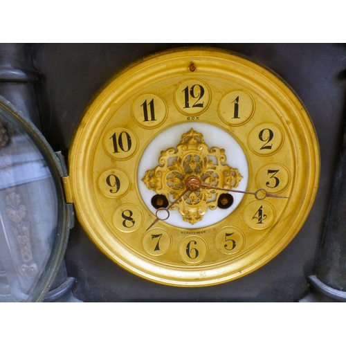 28 - An early 20thC black slate cased mantel clock of architectural form, on a plinth; the movement faced... 