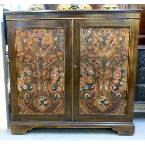 290 - An early/mid mahogany drinks cabinet with a pair of panelled doors, enclosing open shelves and a ref... 