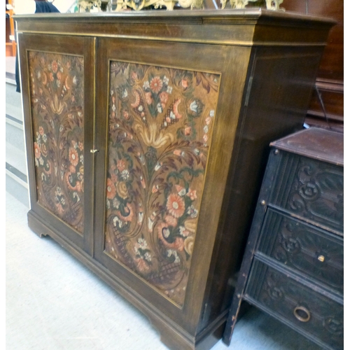 290 - An early/mid mahogany drinks cabinet with a pair of panelled doors, enclosing open shelves and a ref... 
