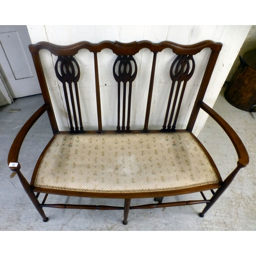 33 - An Edwardian string inlaid mahogany, two person, open arm hall seat, raised on turned legs