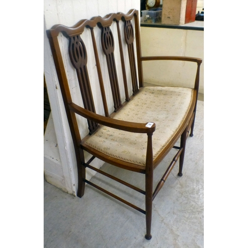 33 - An Edwardian string inlaid mahogany, two person, open arm hall seat, raised on turned legs