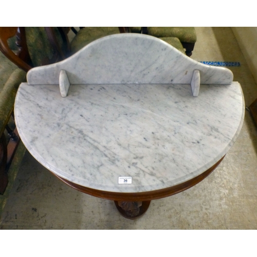 36 - A late Victorian Duchess design mahogany framed marble topped demi-lune washstand, united by cabriol... 