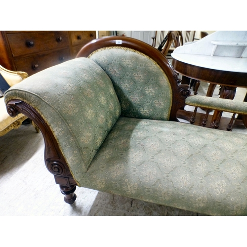 38 - A late Victorian mahogany showwood framed and later fabric upholstered chaise longue, raised on turn... 