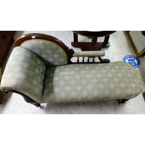 38 - A late Victorian mahogany showwood framed and later fabric upholstered chaise longue, raised on turn... 