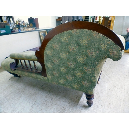 38 - A late Victorian mahogany showwood framed and later fabric upholstered chaise longue, raised on turn... 