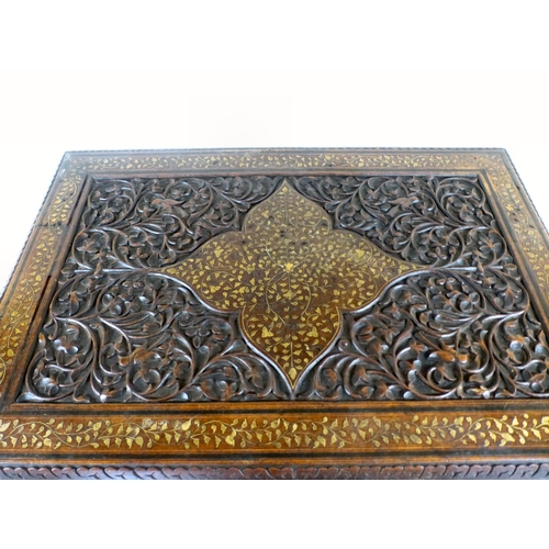 52 - An early 20thC Indian brass inlaid, carved fruitwood, folding occasional table, the drop-in top rais... 