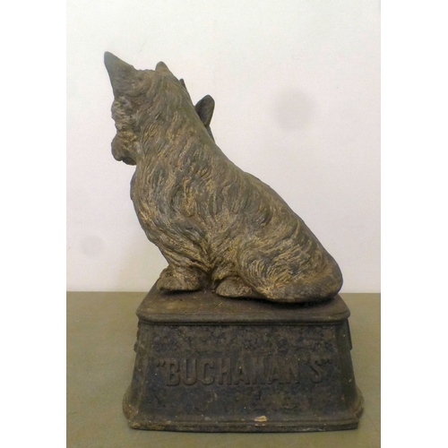 57 - A vintage cast metal advertising display for 'Buchanan's Black and White Whisky', depicting two Scot... 