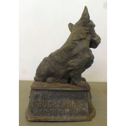 57 - A vintage cast metal advertising display for 'Buchanan's Black and White Whisky', depicting two Scot... 