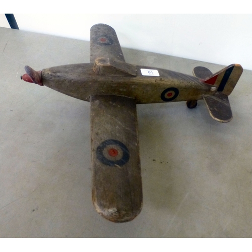61 - A World War II carved and painted wooden Hawker Hurricane toy aeroplane with a metal propellor&nbsp;... 