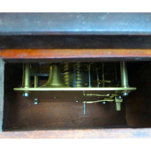 A late Victorian mahogany cased wall clock; the movement faced by a ...