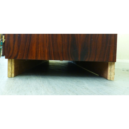 12 - A mid 20thC Danish Skovby rosewood sideboard with four cupboard doors, enclosing interior shelves an... 