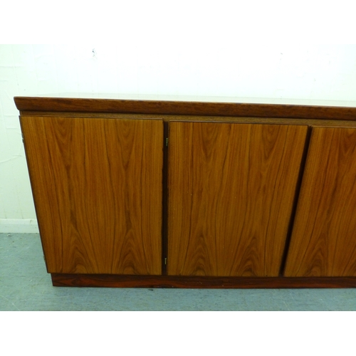 12 - A mid 20thC Danish Skovby rosewood sideboard with four cupboard doors, enclosing interior shelves an... 