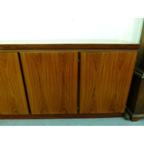 12 - A mid 20thC Danish Skovby rosewood sideboard with four cupboard doors, enclosing interior shelves an... 