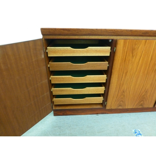 12 - A mid 20thC Danish Skovby rosewood sideboard with four cupboard doors, enclosing interior shelves an... 