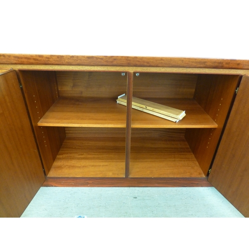 12 - A mid 20thC Danish Skovby rosewood sideboard with four cupboard doors, enclosing interior shelves an... 