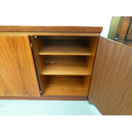 12 - A mid 20thC Danish Skovby rosewood sideboard with four cupboard doors, enclosing interior shelves an... 
