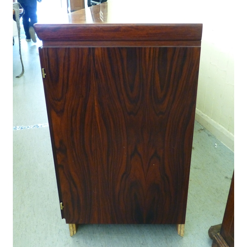 12 - A mid 20thC Danish Skovby rosewood sideboard with four cupboard doors, enclosing interior shelves an... 