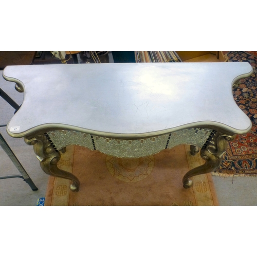 27 - A modern serpentine front console table with silver sprayed finished and mirrored mosaic decoration,... 