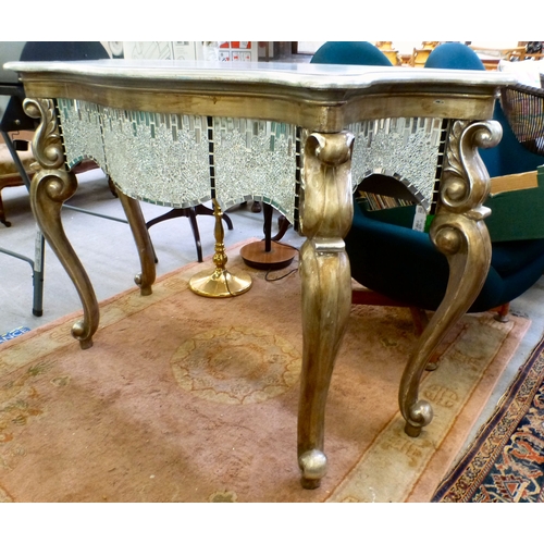 27 - A modern serpentine front console table with silver sprayed finished and mirrored mosaic decoration,... 