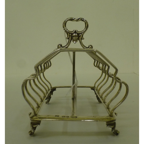 56 - A mid Victorian silver six division toastrack, on scrolled feet&nbsp; London 1852&nbsp; (approx. 275... 