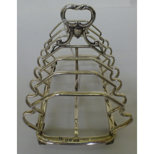 56 - A mid Victorian silver six division toastrack, on scrolled feet&nbsp; London 1852&nbsp; (approx. 275... 