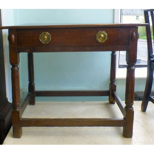 107 - A George III oak single drawer side table, raised on turned and block legs, united by stretchers&nbs... 