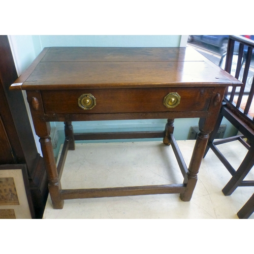 107 - A George III oak single drawer side table, raised on turned and block legs, united by stretchers&nbs... 