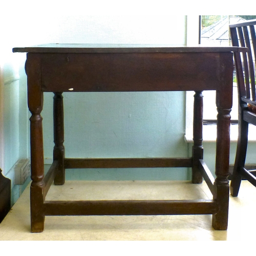 107 - A George III oak single drawer side table, raised on turned and block legs, united by stretchers&nbs... 