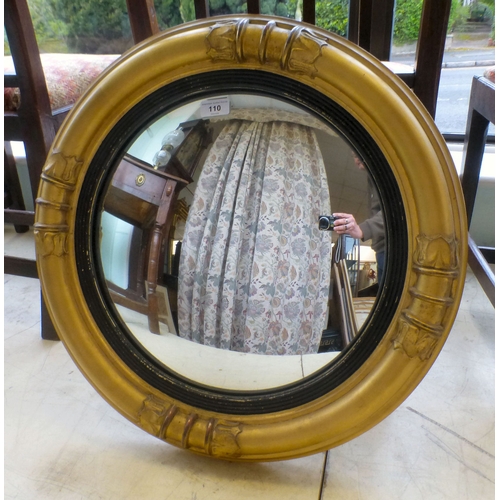 110 - An early 20thC convex mirror, set in a moulded gilt frame&nbsp; 22