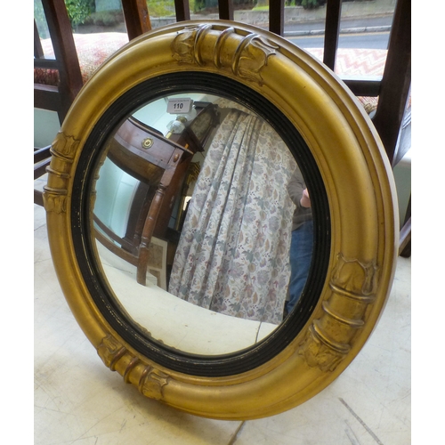 110 - An early 20thC convex mirror, set in a moulded gilt frame&nbsp; 22