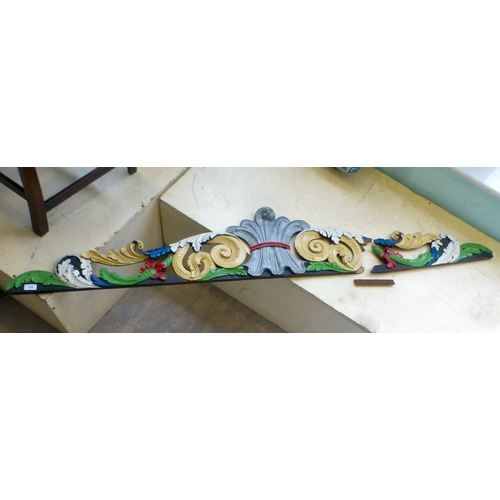 118 - An early 20thC carved and overpainted, overmantel panel, decorated with C-scrolls and foliage&nbsp; ... 