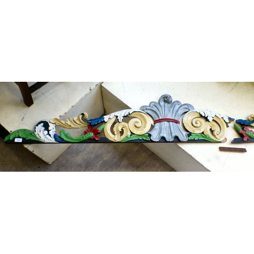 118 - An early 20thC carved and overpainted, overmantel panel, decorated with C-scrolls and foliage&nbsp; ... 