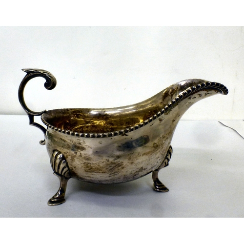 191 - A silver sauce boat with a gadrooned lip, raised on pad feet&nbsp; Sheffield 1944&nbsp; (approx. 247... 