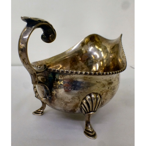 191 - A silver sauce boat with a gadrooned lip, raised on pad feet&nbsp; Sheffield 1944&nbsp; (approx. 247... 